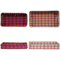 Set of four woven baskets with different color patterns on a white background