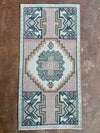 Small rug with geometric pattern on a textured surface