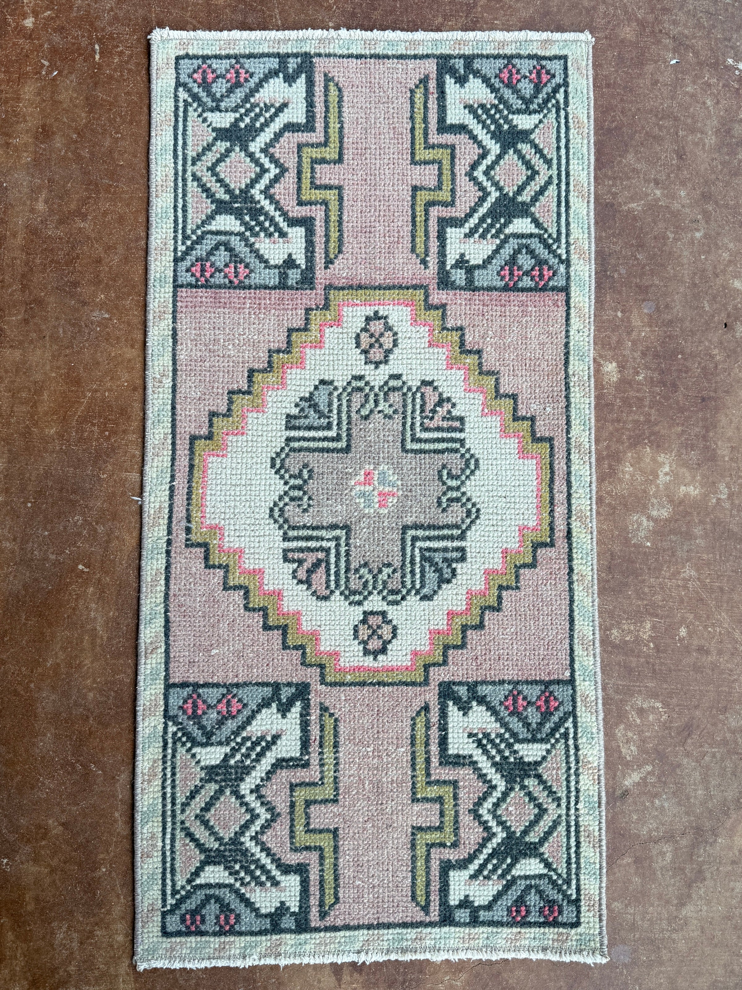 Small rug with geometric pattern on a textured surface