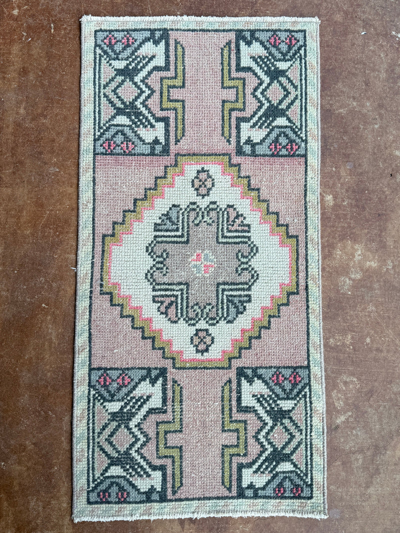 Small rug with geometric pattern on a textured surface