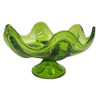 Green glass bowl with wavy design on a white background