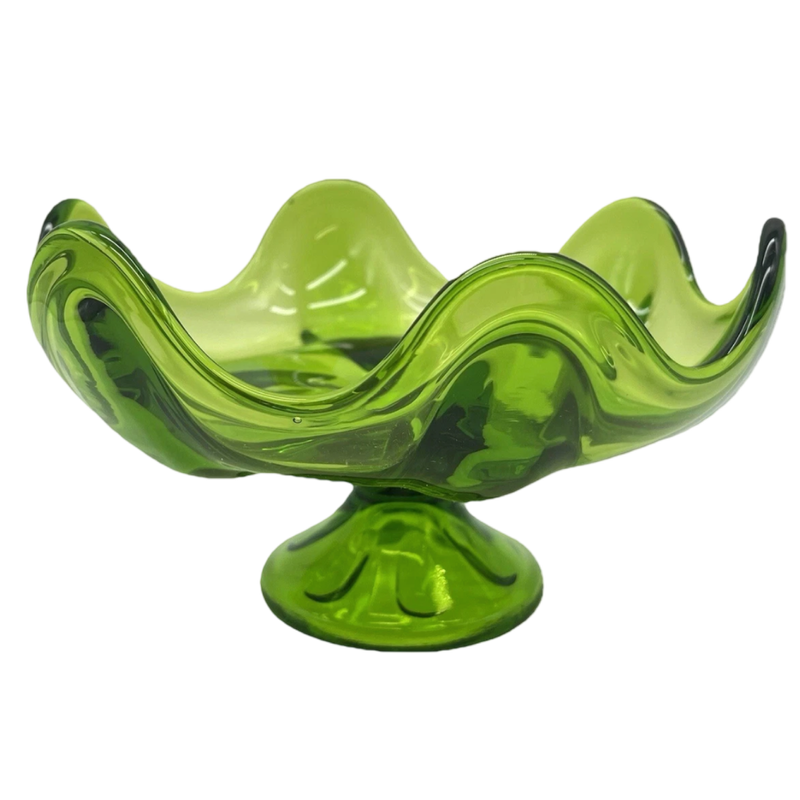 Green glass bowl with wavy design on a white background