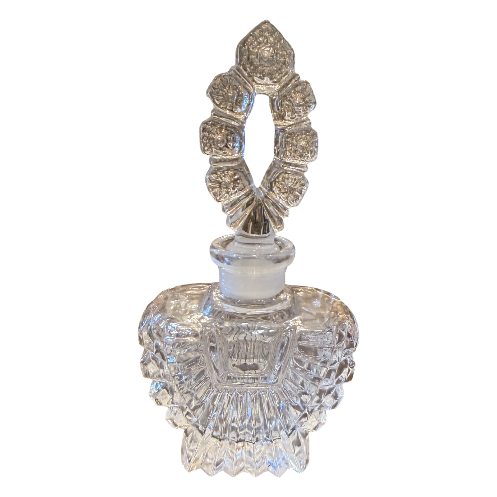Decorative crystal perfume bottle with intricate design on a white background