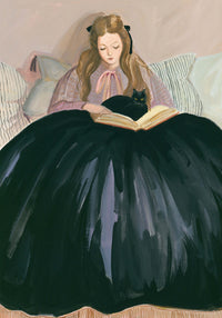 Woman in a long black dress reading a book with a black cat on her lap, sitting on a couch.