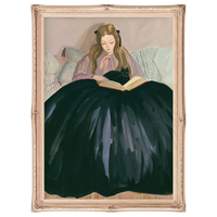 Framed artwork of a woman in a dark dress reading a book with a cat on her lap.