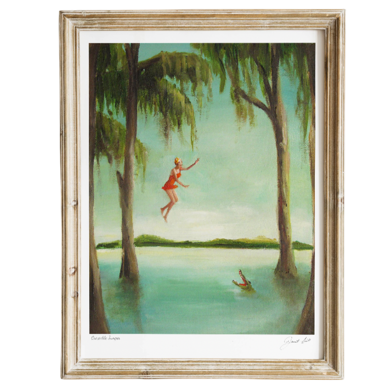 Framed artwork of a woman in a red dress jumping into a lake surrounded by trees.