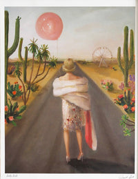 Woman walking on a road with cacti and a Ferris wheel in the background