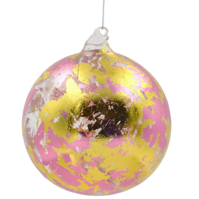 Decorative glass ball with pink, yellow, and white speckles on a white background