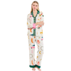 Woman wearing a colorful pajama set with cartoon designs on a white background