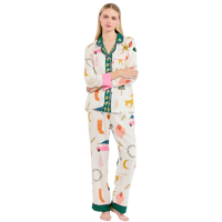 Woman wearing a colorful pajama set with cartoon designs on a white background