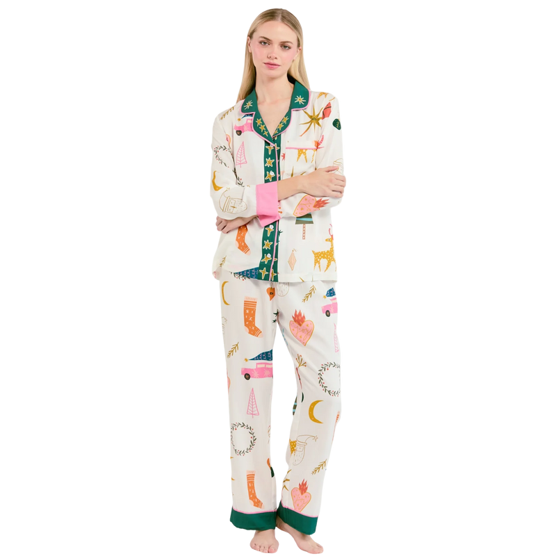 Woman wearing a colorful pajama set with cartoon designs on a white background
