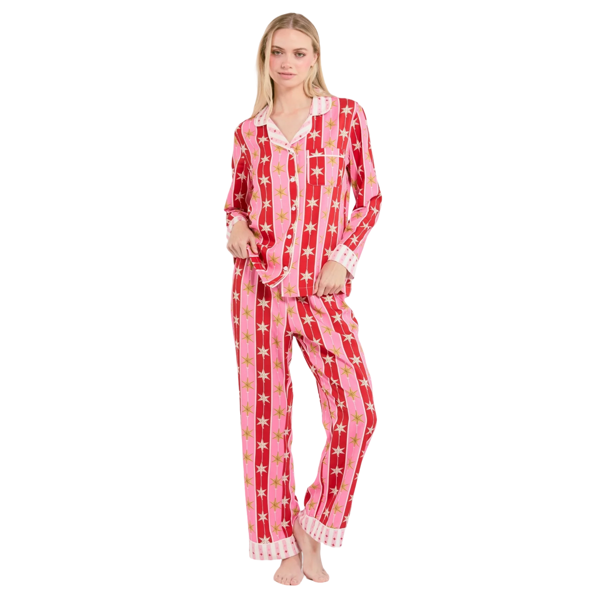 Woman wearing a red and pink star-patterned pajama set on a white background