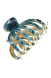 Blue and gold hair clip on a white background