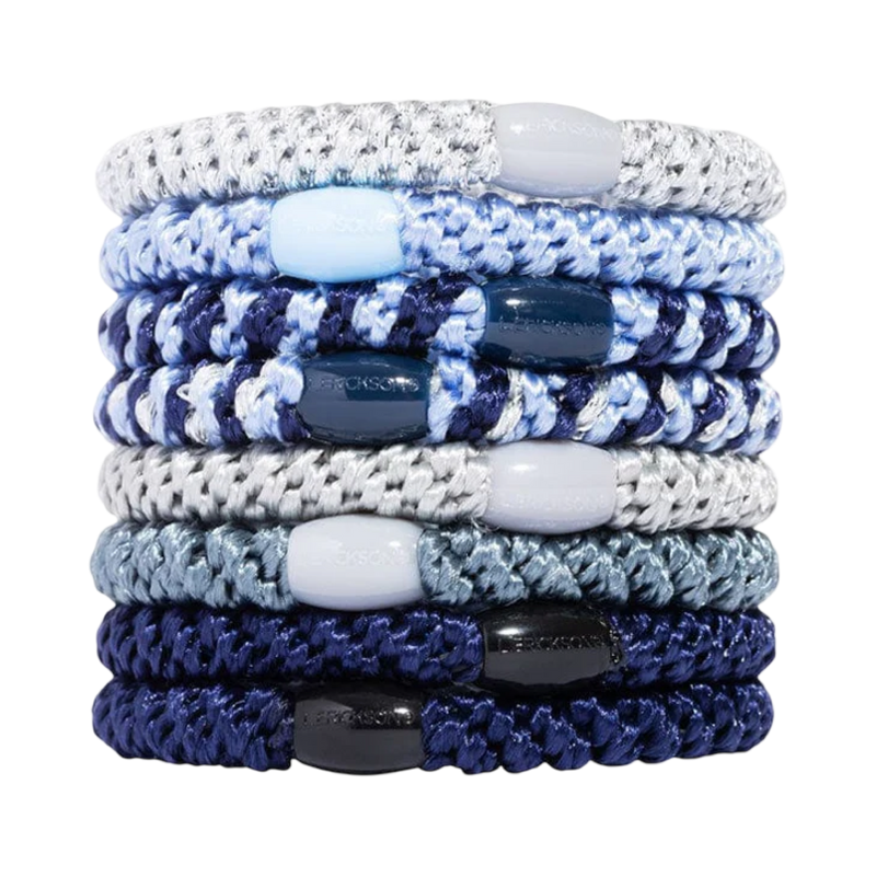 Stack of blue and white braided bracelets on a white background