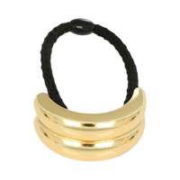 Gold hair tie with three stacked loops on a white background