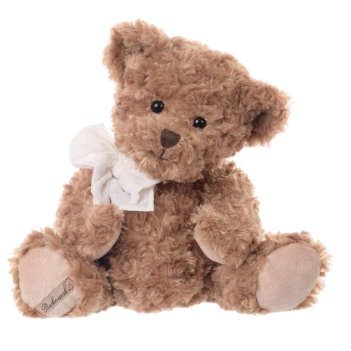 Brown teddy bear with a white bow tie on a white background
