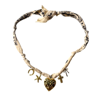 Mandriana, scarf necklace, heart charm necklace, handmade charm jewelry, beachy boho accessory, cross charm necklace, starfish necklace, symbolic jewelry, neutral bandana necklace, one of a kind statement piece, artisanal jewelry, boho chic accessories, charm scarf necklace, textured heart necklace
