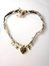 Mandriana, scarf necklace, heart charm necklace, handmade charm jewelry, beachy boho accessory, cross charm necklace, starfish necklace, symbolic jewelry, neutral bandana necklace, one of a kind statement piece, artisanal jewelry, boho chic accessories, charm scarf necklace, textured heart necklace
