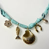 Mandriana, scarf necklace, shell charm necklace, ocean inspired jewelry, coastal style accessory, seafoam green bandana necklace, fish charm, horseshoe necklace, beachy boho jewelry, handmade charm necklace, unique summer necklace, mermaidcore accessory, one of a kind jewelry, artisanal necklace