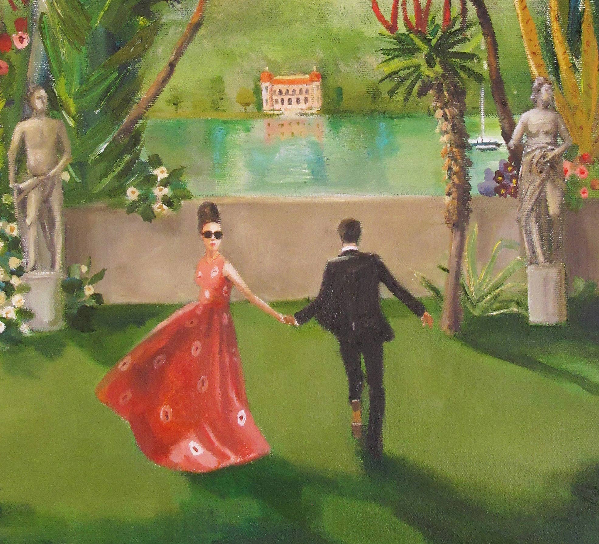 Couple holding hands in a garden with statues and a lake in the background