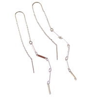 Two gold necklaces on a white background