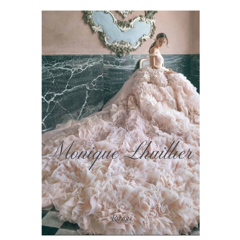 White wedding dress with a long train on a marble floor, featuring the brand 'Monique Lhuillier'.