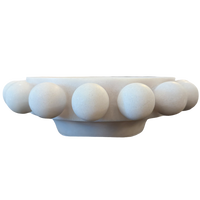 A white marble decorative bowl with a raised beaded border, shown from a side profile view against a plain white background.