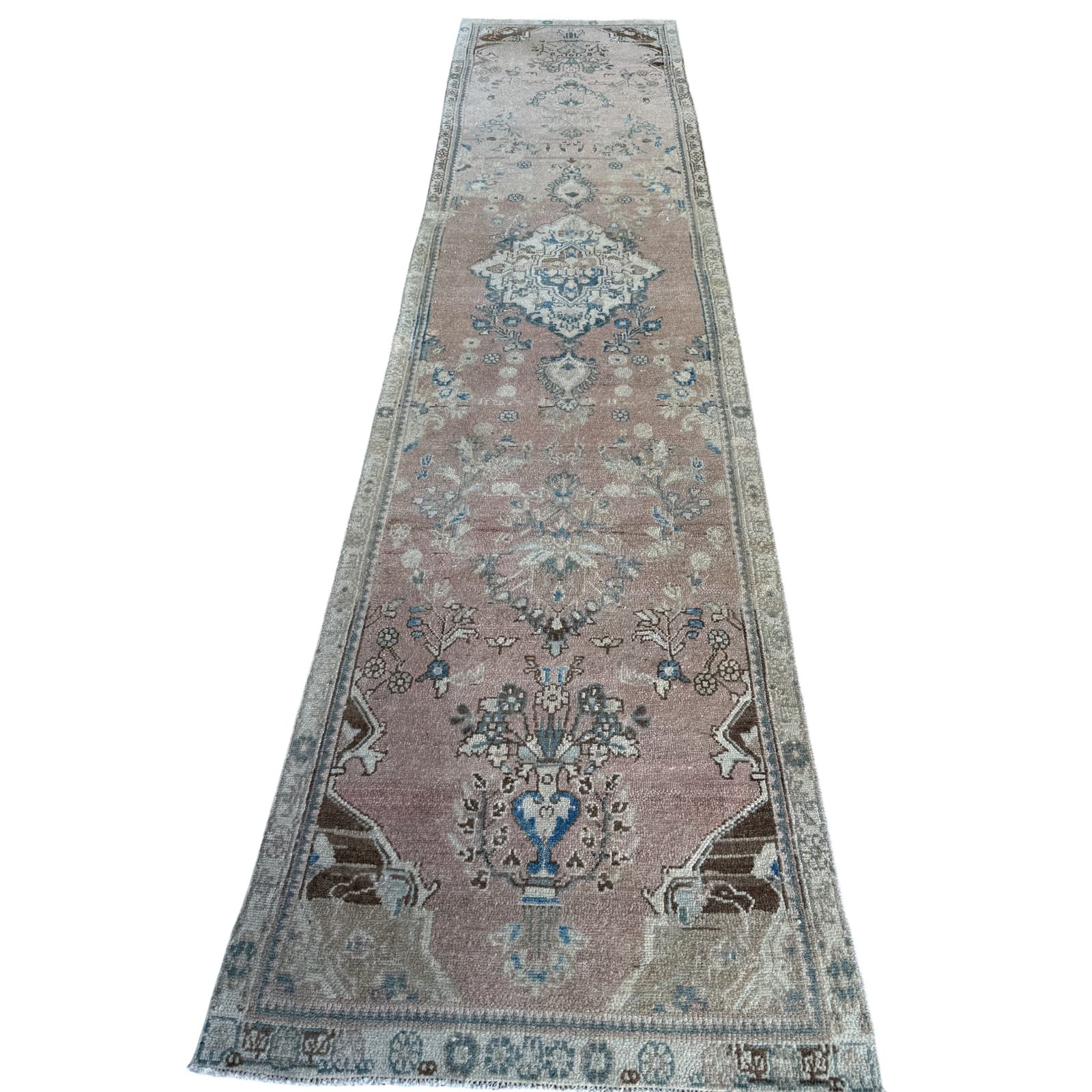 One-of-a-kind vintage Persian runner rug measuring approximately 2'11" x 12'5" with a faded dusty rose ground, blue and turquoise medallion motifs, ivory border and timeworn details.
