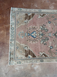 One-of-a-kind vintage Persian runner rug measuring approximately 2'11" x 12'5" with a faded dusty rose ground, blue and turquoise medallion motifs, ivory border and timeworn details.