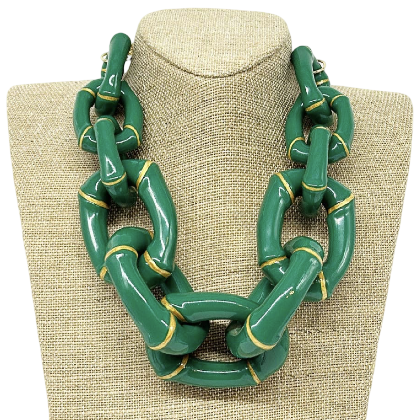 Green chain necklace on a beige fabric stand