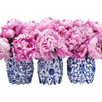 Pink flowers in blue and white patterned vases on a white background