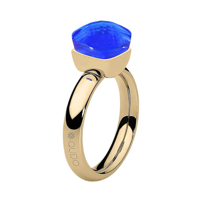 Gold ring with a blue gemstone on a white background