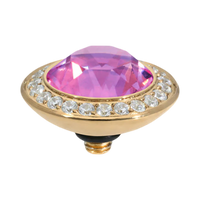Pink gemstone in a gold setting with clear stones on a white background