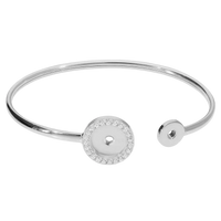 Silver bangle with a round embellishment on a white background