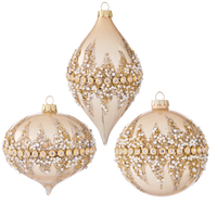 Three decorative Christmas ornaments with gold and pearl patterns on a white background