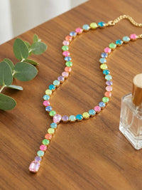 Sorrelli Candy Carnival crystal lariat Y-necklace with yellow, mint, blue, and pink stones in a bright gold-tone finish