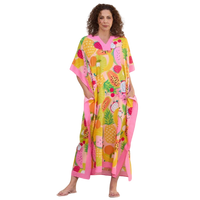 Woman wearing a colorful fruit patterned dress on a white background