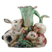 Ceramic vase with rabbit design on a white background