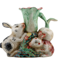 Ceramic vase with rabbit design on a white background
