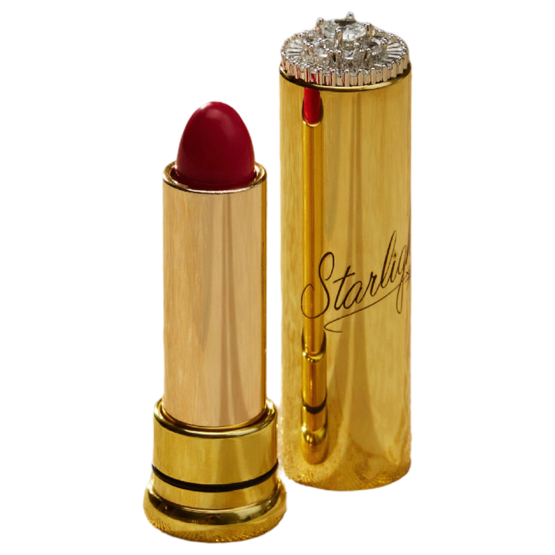 A luxury lipstick shown open next to its cap, both in a polished gold finish. The lipstick bullet is a deep red, and the cap features a rhinestone-embellished top and the brand name 'Starlight' in cursive script.