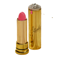 A gold-plated lipstick with a pink bullet, shown alongside its open case which features a rhinestone-embellished top and the brand name 'Starlight' printed in black script.