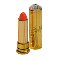 Starlight Vintage Cosmetics Holly’s Peach lipstick in warm peachy-pink shade with vintage-inspired gold metal tube.