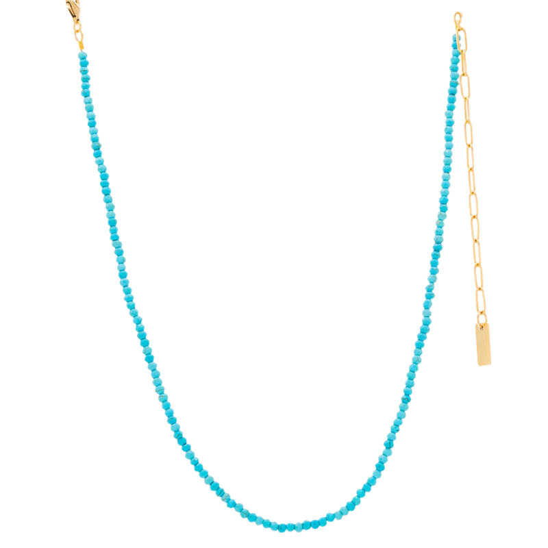 Turquoise beaded necklace with a gold chain on a white background
