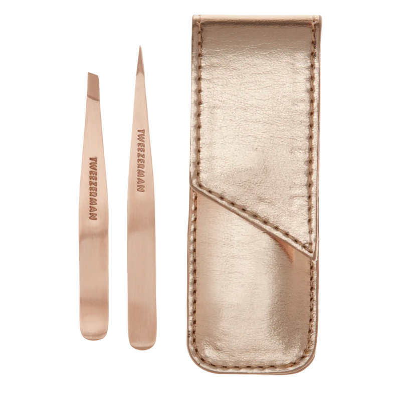 Rose gold tweezers with a matching case on a white background