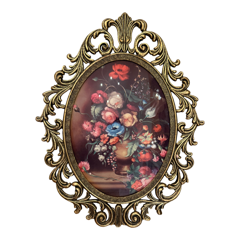 An ornate oval wall art piece featuring a classical-style floral bouquet painting in a gold-toned baroque frame, set against a plain white background.