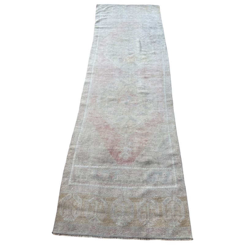 Vintage Turkish runner rug measuring approximately 2'9½" x 8'10" with a softly faded traditional pattern in blush pink, sage, blue-gray, ivory and sand tones.