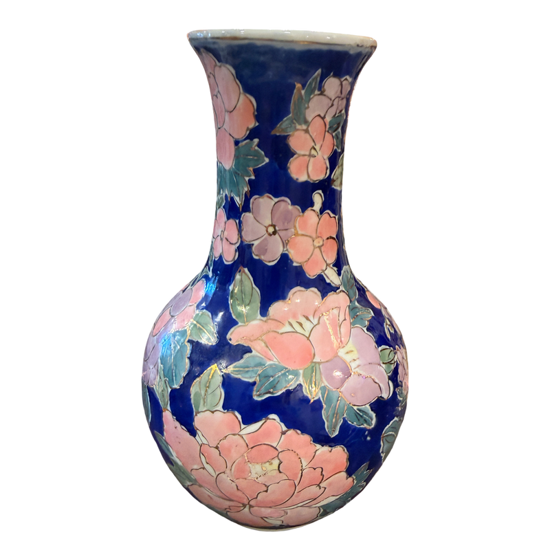 A ceramic vase with a dark blue glaze decorated with large pink flowers and green leaves, shown against a plain white background.