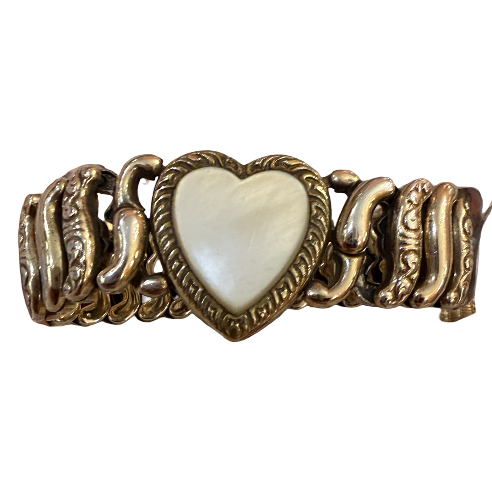 A vintage-style gold-tone chain bracelet featuring a central heart-shaped inlay with a pearlescent white mother-of-pearl finish, set against a plain white background.