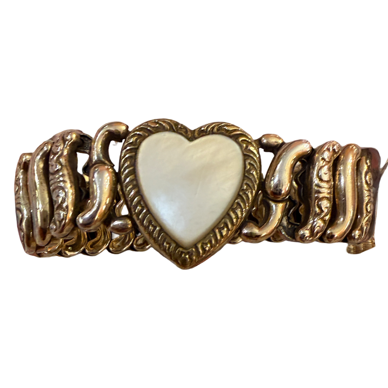 A vintage-style gold-tone chain bracelet featuring a central heart-shaped inlay with a pearlescent white mother-of-pearl finish, set against a plain white background.
