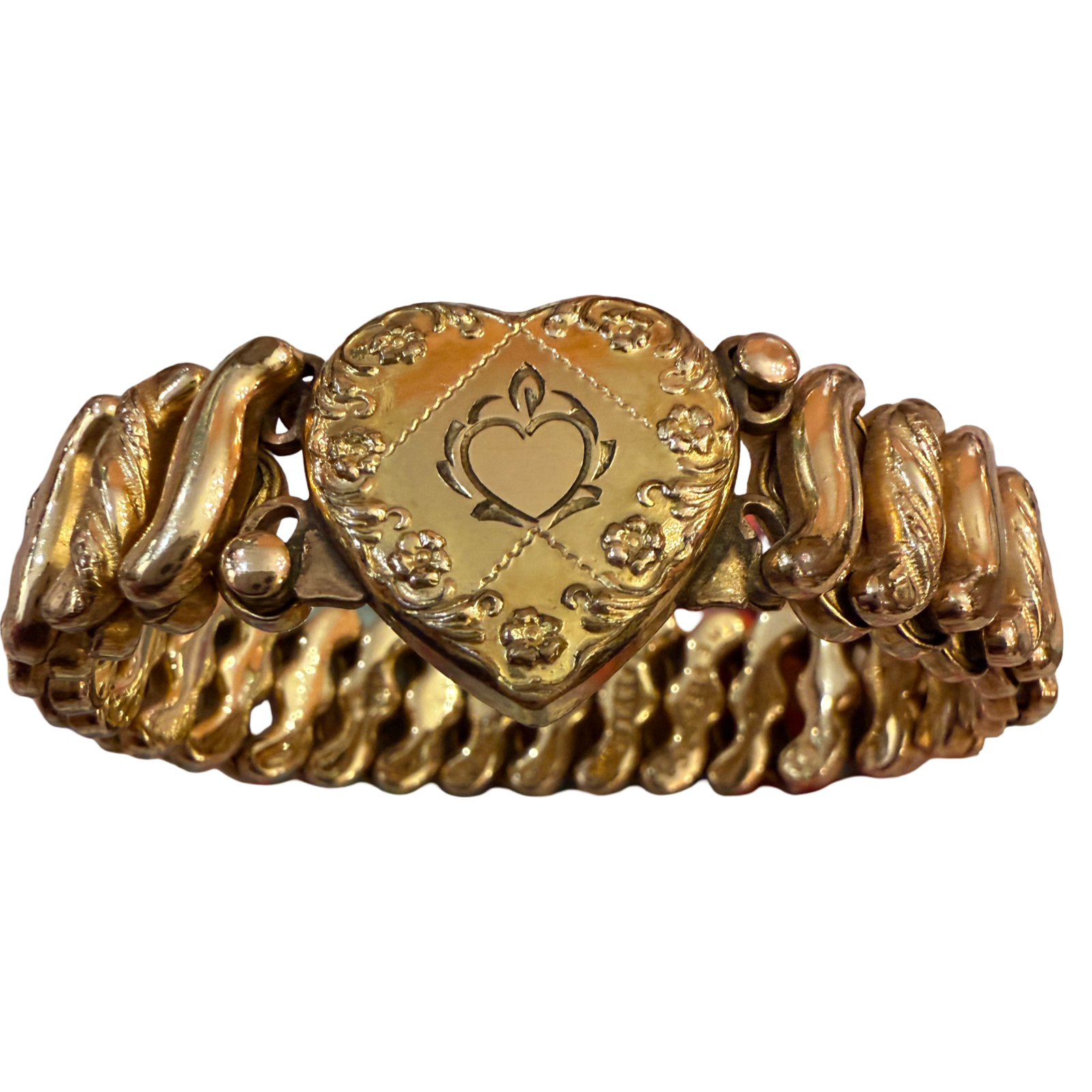 A vintage gold heart-shaped bracelet with a central engraved heart medallion and textured, wavy side bands, shown on a plain white background.